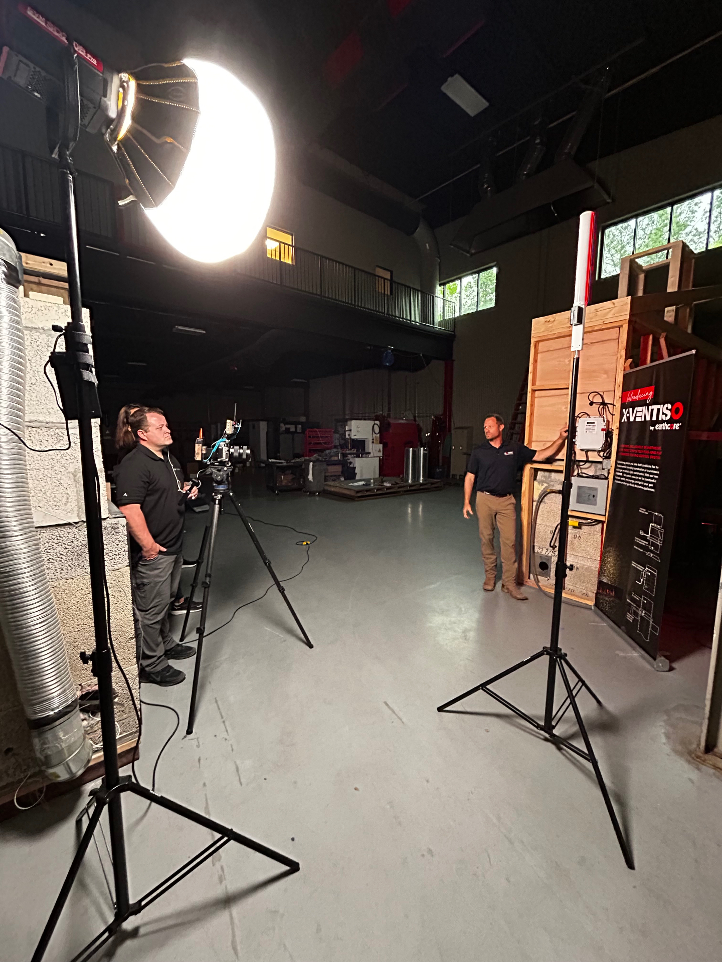 Producer and camera operator capturing a product demo with studio lighting